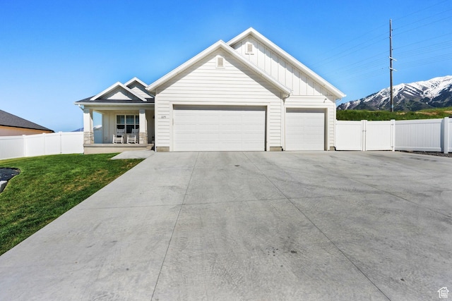 1279 S 50 E, Salem, UT 84653 - view of front of house featuring a mountain view, board and batten siding, concrete driveway, an attached garage, and a porch