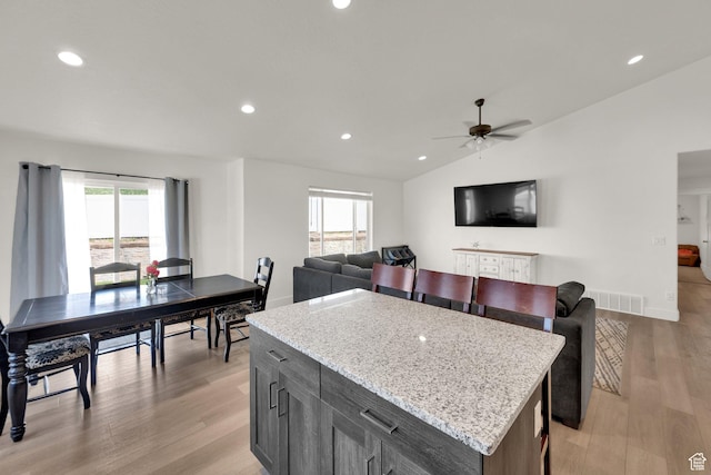 1279 S 50 E, Salem, UT 84653 - kitchen featuring vaulted ceiling, plenty of natural light, light wood-style flooring, ceiling fan, and a center island