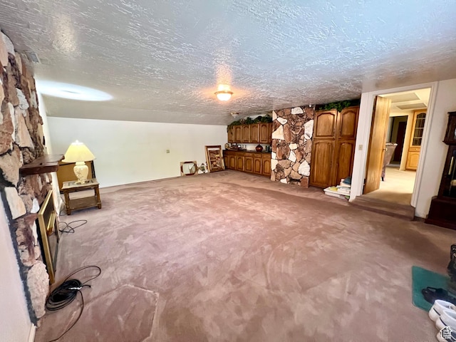 310 S 100 W, Monroe, UT 84754 - unfurnished room featuring light carpet, a textured ceiling, and a fireplace