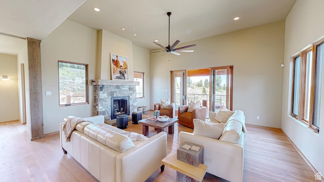 22677 E Snowbird Dr Unit 47, Spanish Fork, UT 84660 - living area featuring healthy amount of natural light, a high ceiling, light wood-style flooring, a fireplace, and ceiling fan