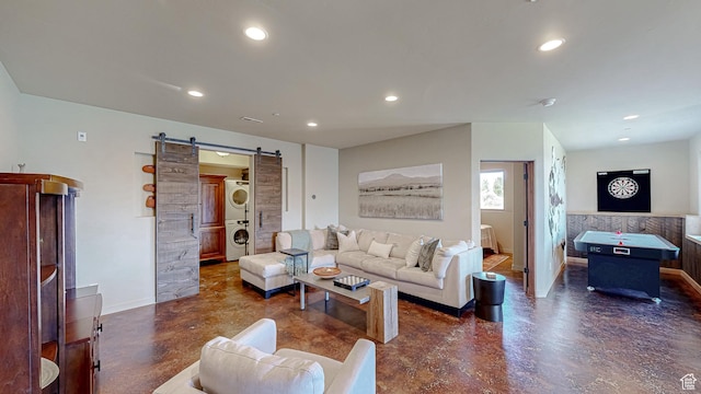 22677 E Snowbird Dr Unit 47, Spanish Fork, UT 84660 - living room featuring stacked washer / dryer, concrete floors, a barn door, recessed lighting, and baseboards