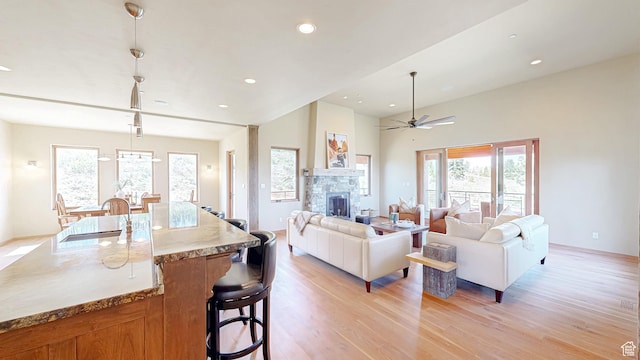 22677 E Snowbird Dr Unit 47, Spanish Fork, UT 84660 - living area with light wood finished floors, plenty of natural light, a stone fireplace, ceiling fan, and recessed lighting