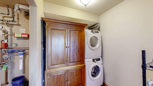 22677 E Snowbird Dr Unit 47, Spanish Fork, UT 84660 - laundry room featuring stacked washer / drying machine, cabinet space, and baseboards