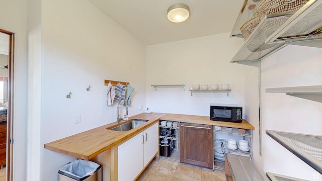 22677 E Snowbird Dr Unit 47, Spanish Fork, UT 84660 - kitchen featuring black microwave, wood counters, white cabinetry, premium range hood, and light stone finish floors