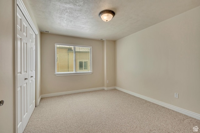 1804 E Longbranch Ct, Draper Ut Cnty, UT 84020 - unfurnished bedroom with a textured ceiling, a closet, carpet, and baseboards