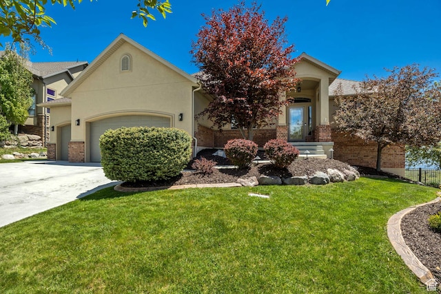 1804 E Longbranch Ct, Draper Ut Cnty, UT 84020 - view of property hidden behind natural elements featuring an attached garage, brick siding, concrete driveway, and stucco siding