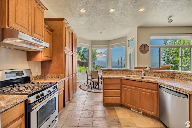 1804 E Longbranch Ct, Draper Ut Cnty, UT 84020 - kitchen with appliances with stainless steel finishes, under cabinet range hood, a sink, a textured ceiling, and a chandelier