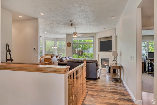 1804 E Longbranch Ct, Draper Ut Cnty, UT 84020 - kitchen with ceiling fan, a glass covered fireplace, wood finished floors, recessed lighting, and baseboards