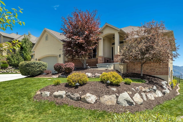 1804 E Longbranch Ct, Draper Ut Cnty, UT 84020 - obstructed view of property featuring brick siding, a garage, a front yard, and stucco siding