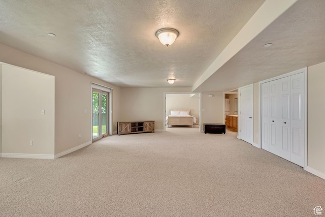 1804 E Longbranch Ct, Draper Ut Cnty, UT 84020 - unfurnished living room with light colored carpet, a textured ceiling, and baseboards
