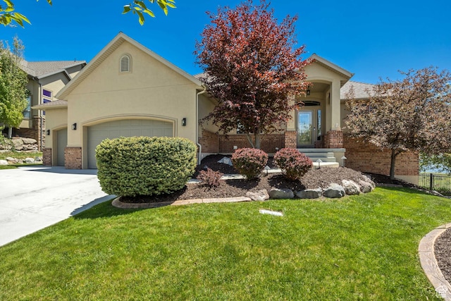 1804 E Longbranch Ct, Draper Ut Cnty, UT 84020 - view of property hidden behind natural elements with an attached garage, brick siding, concrete driveway, and stucco siding