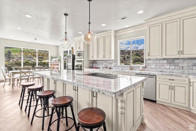 1079 S 400 E, Nephi, UT 84648 - kitchen featuring stainless steel appliances, light wood-style floors, a center island, backsplash, and recessed lighting