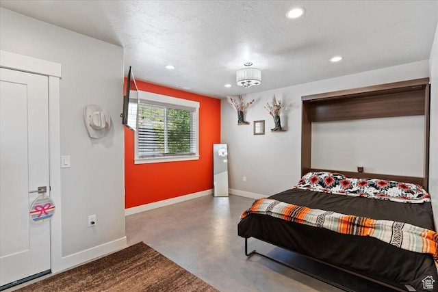 1243 Kotter Dr, Brigham City, UT 84302 - bedroom with concrete floors, recessed lighting, baseboards, and a textured ceiling