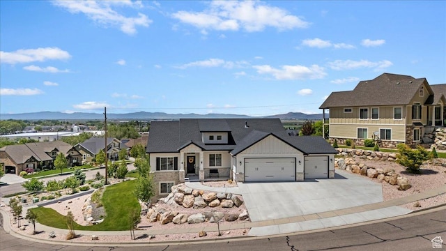 1243 Kotter Dr, Brigham City, UT 84302 - view of front of home featuring a mountain view, a garage, concrete driveway, and board and batten siding