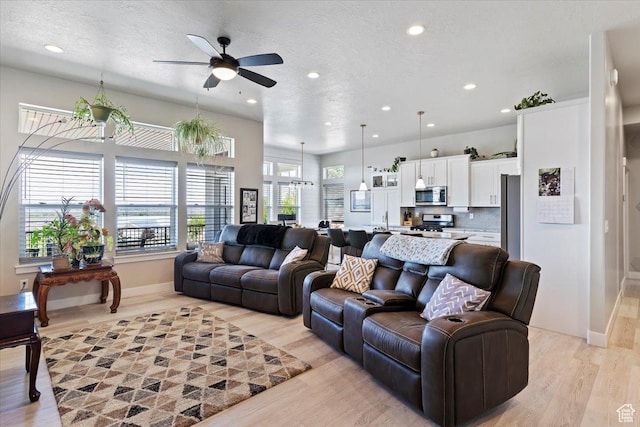 1243 Kotter Dr, Brigham City, UT 84302 - living room featuring a ceiling fan, recessed lighting, light wood-style floors, baseboards, and a textured ceiling