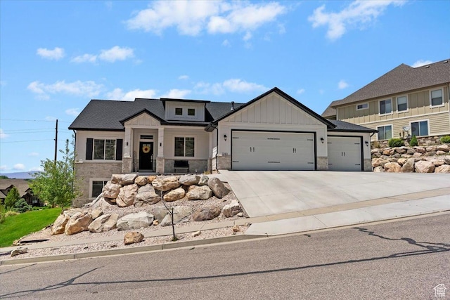 1243 Kotter Dr, Brigham City, UT 84302 - modern inspired farmhouse with a garage, stone siding, board and batten siding, and concrete driveway
