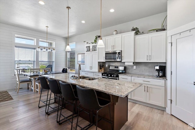 1243 Kotter Dr, Brigham City, UT 84302 - kitchen featuring stainless steel appliances, a sink, backsplash, recessed lighting, and white cabinetry