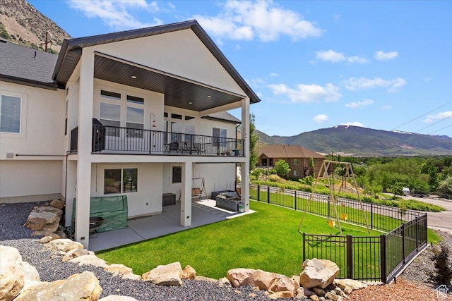 1243 Kotter Dr, Brigham City, UT 84302 - back of house with a balcony, a mountain view, a patio, and stucco siding