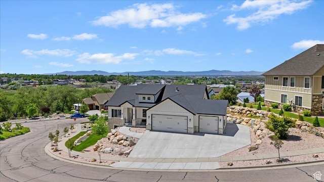 1243 Kotter Dr, Brigham City, UT 84302 - view of front facade featuring a garage, a mountain view, driveway, and board and batten siding