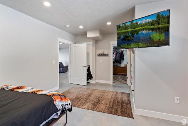 1243 Kotter Dr, Brigham City, UT 84302 - bedroom featuring finished concrete flooring, baseboards, recessed lighting, a spacious closet, and a closet