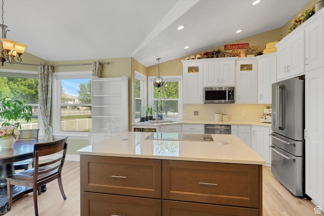 42 E Frontier Ct, Saratoga Springs, UT 84045 - kitchen featuring appliances with stainless steel finishes, lofted ceiling, a sink, a chandelier, and plenty of natural light
