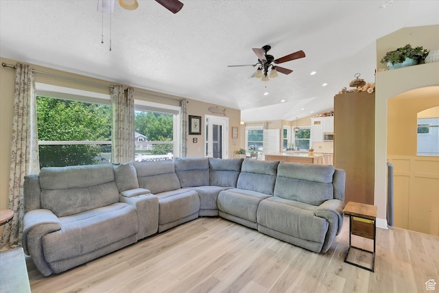 42 E Frontier Ct, Saratoga Springs, UT 84045 - living room featuring ceiling fan, plenty of natural light, light wood finished floors, lofted ceiling, and a textured ceiling
