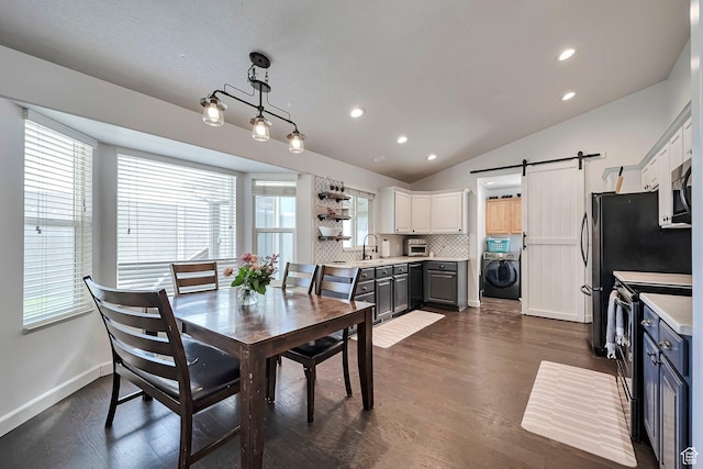 267 W Noah Cir S, Murray, UT 84107 - dining area with washer / dryer, vaulted ceiling, a barn door, plenty of natural light, and dark wood-style flooring