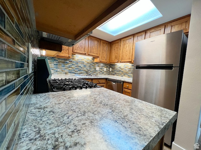 543 S 900 E Unit C3, Salt Lake City, UT 84102 - kitchen with appliances with stainless steel finishes, brown cabinets, a sink, and backsplash