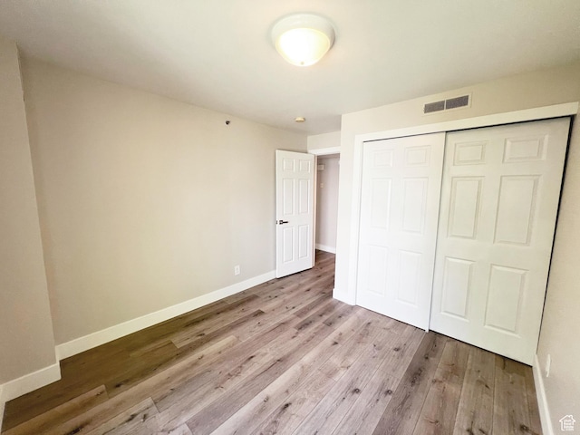 543 S 900 E Unit C3, Salt Lake City, UT 84102 - unfurnished bedroom with wood finished floors, baseboards, and a closet