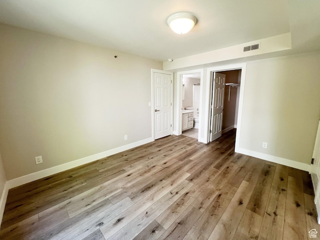 543 S 900 E Unit C3, Salt Lake City, UT 84102 - unfurnished bedroom featuring hardwood / wood-style flooring, baseboards, a spacious closet, and ensuite bathroom