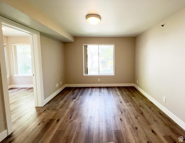 543 S 900 E Unit C3, Salt Lake City, UT 84102 - unfurnished room with healthy amount of natural light, dark wood-type flooring, and baseboards