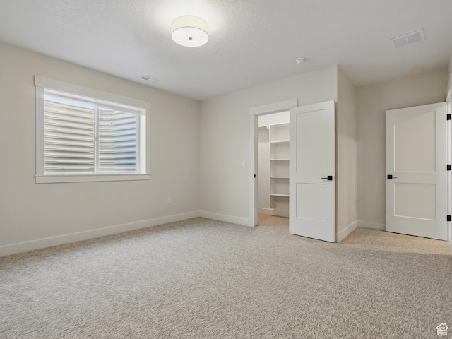 2023 S 150 W, Perry, UT 84302 - unfurnished bedroom featuring light colored carpet, baseboards, and a spacious closet