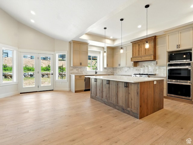2023 S 150 W, Perry, UT 84302 - kitchen featuring light countertops, decorative backsplash, a kitchen island, appliances with stainless steel finishes, and light wood-style floors
