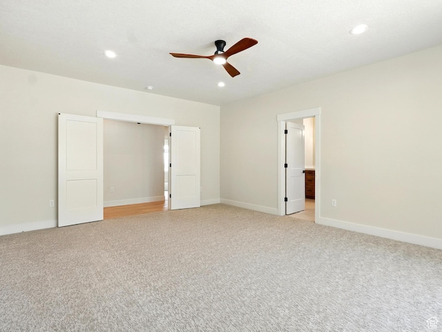 2023 S 150 W, Perry, UT 84302 - unfurnished bedroom featuring light colored carpet, recessed lighting, baseboards, ceiling fan, and ensuite bath