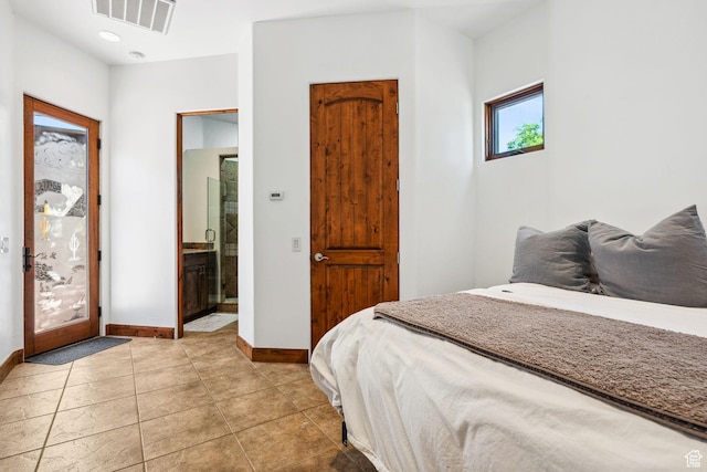 2090 N Tuweap Dr Unit 9, St George, UT 84770 - bedroom featuring baseboards, light tile patterned floors, and ensuite bathroom