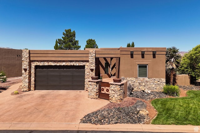 2090 N Tuweap Dr Unit 9, St George, UT 84770 - adobe home with an attached garage, concrete driveway, stone siding, and stucco siding