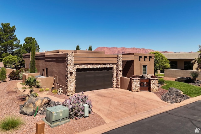 2090 N Tuweap Dr Unit 9, St George, UT 84770 - pueblo-style house with a garage, stucco siding, driveway, and a mountain view