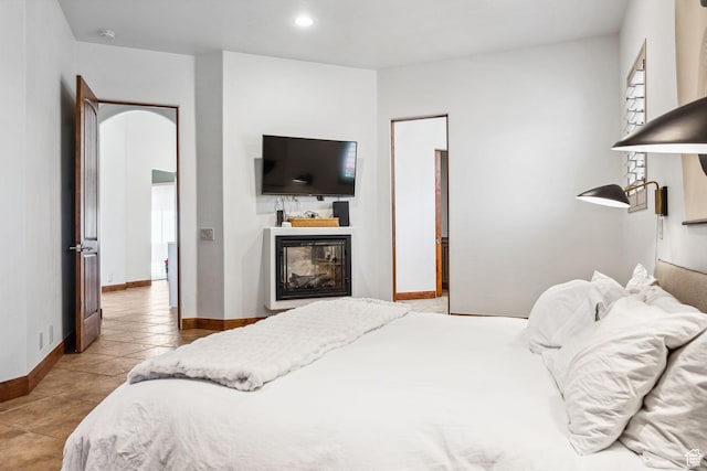 2090 N Tuweap Dr Unit 9, St George, UT 84770 - tiled bedroom featuring baseboards, a glass covered fireplace, and recessed lighting