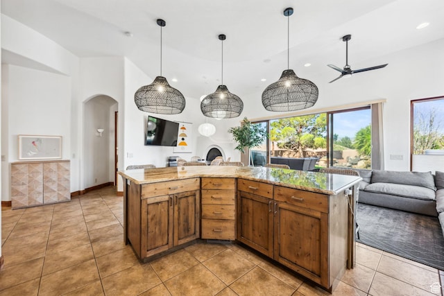 2090 N Tuweap Dr Unit 9, St George, UT 84770 - kitchen featuring open floor plan, arched walkways, brown cabinets, and recessed lighting