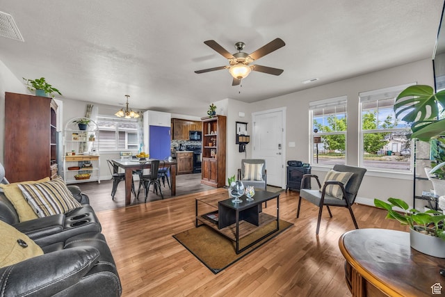 161 E 27th St S, Ogden, UT 84401 - living room featuring light wood finished floors, ceiling fan, a chandelier, and baseboards