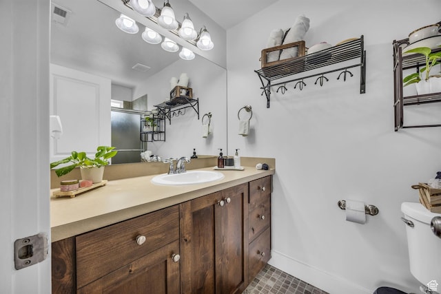 161 E 27th St S, Ogden, UT 84401 - bathroom with vanity, toilet, a shower with door, and baseboards