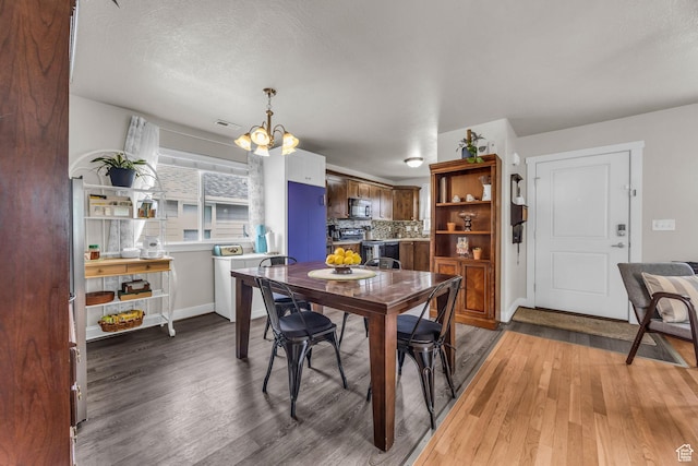 161 E 27th St S, Ogden, UT 84401 - dining room featuring a chandelier, light wood-type flooring, and baseboards