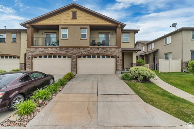 287 W 680 N, Centerville, UT 84014 - townhome / multi-family property with stucco siding, stone siding, driveway, and a balcony