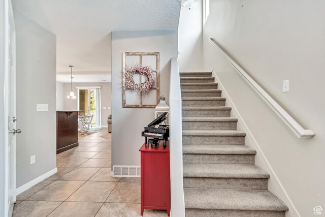 287 W 680 N, Centerville, UT 84014 - staircase featuring tile patterned floors and baseboards