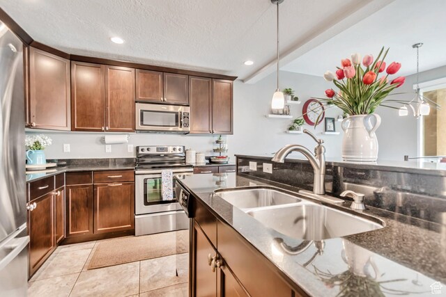 287 W 680 N, Centerville, UT 84014 - kitchen featuring stainless steel appliances, a sink, dark stone countertops, pendant lighting, and recessed lighting