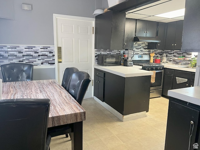 2849 S 8950 W, Magna, UT 84044 - kitchen with stainless steel gas stove, black microwave, and backsplash