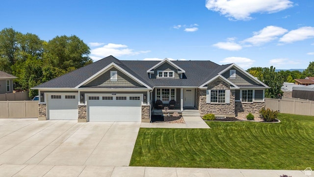 3498 W Harvestwood Ln S, Riverton, UT 84065 - craftsman-style house with stone siding, driveway, an attached garage, and covered porch
