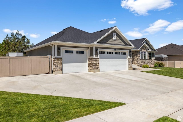 3498 W Harvestwood Ln S, Riverton, UT 84065 - craftsman inspired home featuring an attached garage, driveway, and stone siding