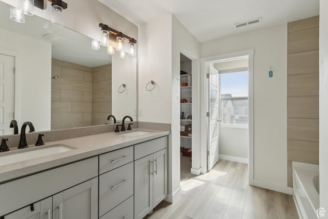 4254 E Center Point St, Eagle Mountain, UT 84005 - bathroom with double vanity, a bath, baseboards, and wood finished floors