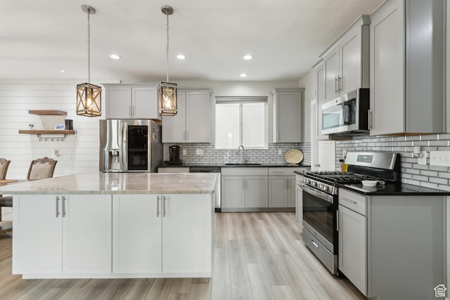 4254 E Center Point St, Eagle Mountain, UT 84005 - kitchen featuring appliances with stainless steel finishes, a sink, a center island, light wood-type flooring, and recessed lighting